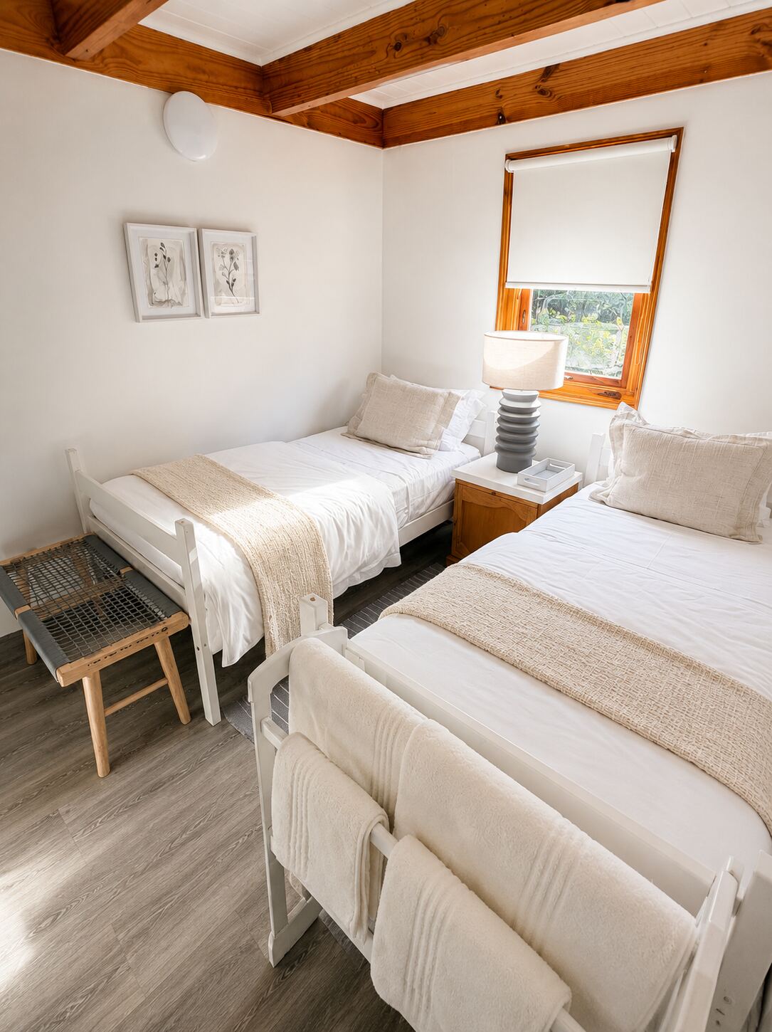 Ground-floor twin bedroom with two single beds and a garden window